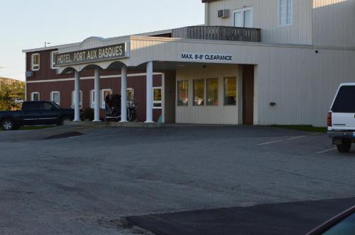 a building with a car parked in a parking lot at Hotel Port Aux Basques in Channel-Port aux Basques