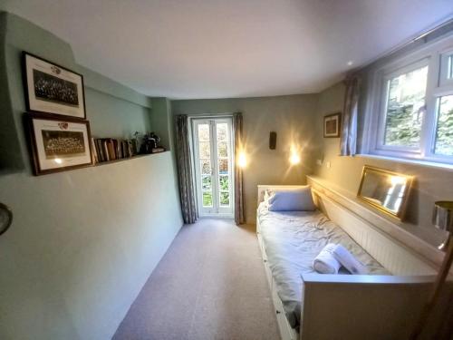 a small room with a bed and a window at Truly Paradise Cottage in Golant