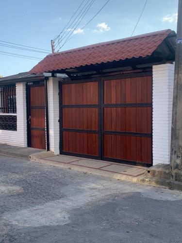a building with two garage doors on a street at Hermosa Casa Central - Rositas's house in La Mesa