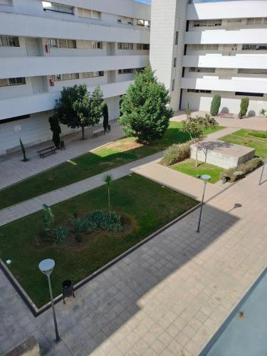 a courtyard in front of a white building at El mirador de la Ría in Isla Cristina