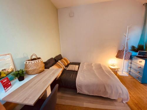 a room with a bed and a table in it at Casa Doutre in Angers