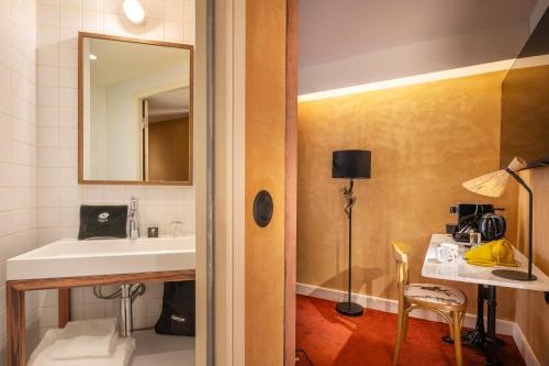 a bathroom with a sink and a mirror at Kopster Hotel Paris Porte de Versailles in Paris