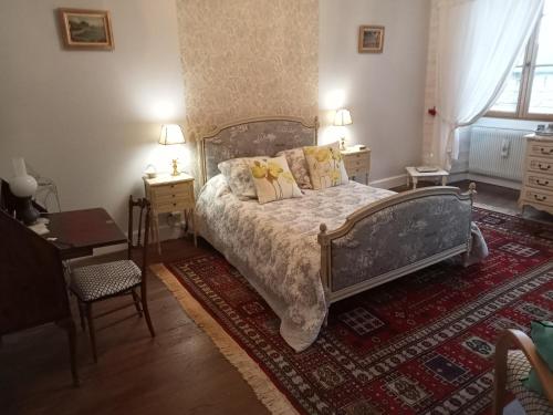 a bedroom with a bed with pillows on it at MAISON GAY LUSSAC St LEONARD DE NOBLAT in Saint-Léonard-de-Noblat