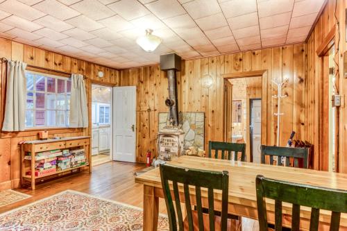 a dining room with a table and chairs and wooden walls at The Cedars Cabin in Welches