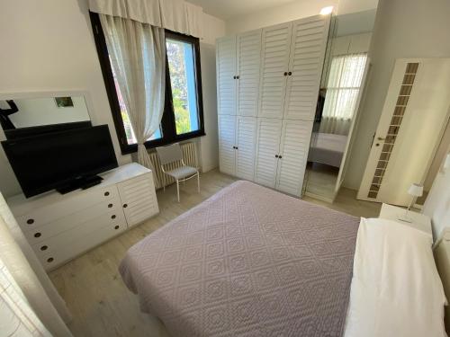 Een bed of bedden in een kamer bij Villetta Trieste-Flexrent Abissinia