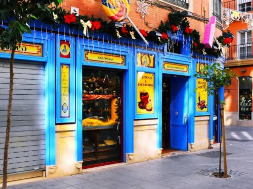 a store front with blue paint on the side of a building at Espléndido estudio en el Centro Histórico de Málaga. in Málaga