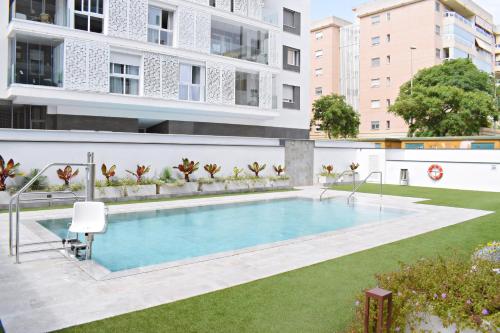 un apartamento con piscina en un edificio en Amalia's Home: Luminoso apartamento muy cerca de la playa, en Málaga