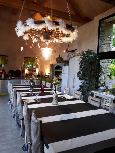 une grande salle à manger avec une grande table et des chaises dans l'établissement Aux Greniers à Rêves, à Plestan