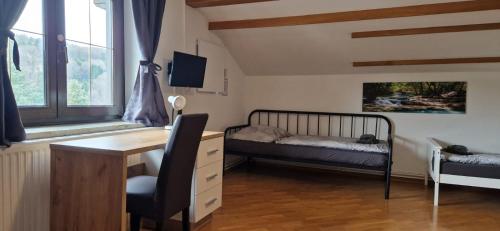 a bedroom with a desk and a bed and window at Haus Mitterfeld in Kasten bei Böheimkirchen