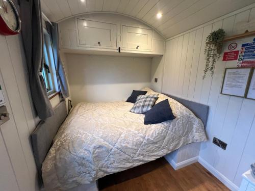 a bedroom in a tiny house with a bed at Lavender Retreat with Private Hot Tub in Upper Hulme