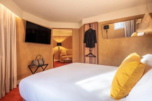 a hotel room with a bed and a television at Kopster Hotel Paris Porte de Versailles in Paris