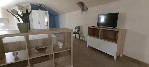 a living room with a tv on top of a cabinet at Ristel Casa Vacanza in Lizzano