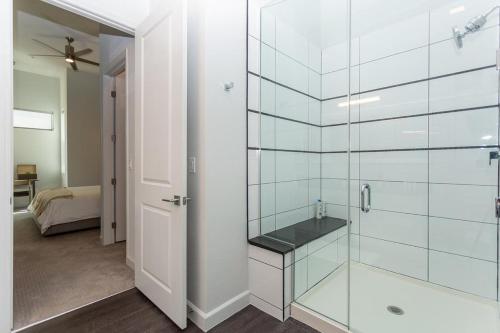 a bathroom with a glass shower with a sink at Landing - Modern Apartment with Amazing Amenities (ID3121X08) in Las Vegas
