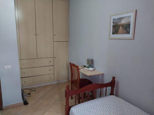 a bedroom with a bed and a desk and a cabinet at Home sweet Home 2 - Guest House in Tirana