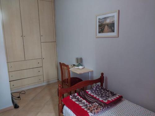 a bedroom with a bed and a chair and a cabinet at Home sweet Home 2 - Guest House in Tirana