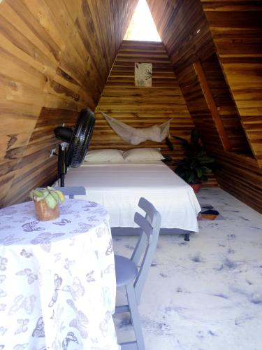 a bedroom with a bed and a table in a room at tukamping in Minca