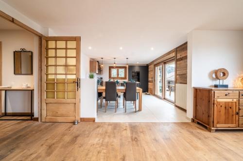 a kitchen and dining room with a table and chairs at Chalet de la Joux in Saint-Sigismond