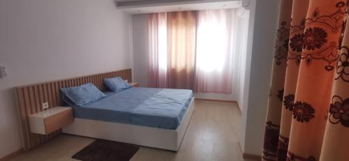 a small bedroom with a bed and a window at Ondas Relax House in Praia