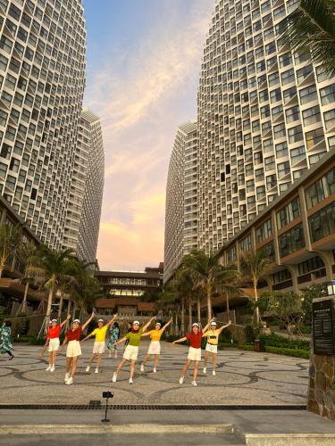 a group of people dancing in front of tall buildings at Mandala Muine M2012A in Phan Thiet