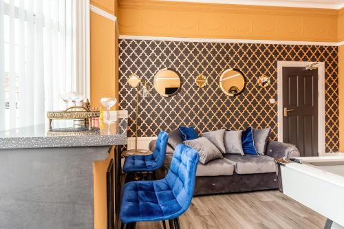 a living room with a couch and blue chairs at Room 07 - Sandhaven Rooms Double in South Shields
