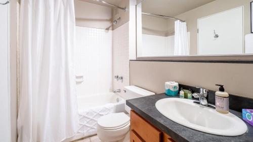 a bathroom with a sink and a toilet and a shower at Landing - Modern Apartment with Amazing Amenities (ID5125X39) in Chicago