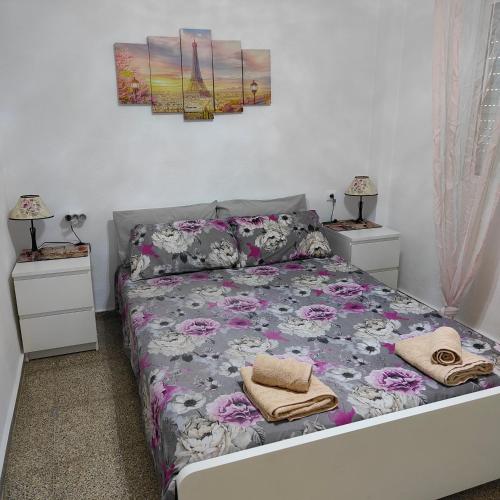 a bedroom with a bed with two night stands at Relaxed Space in the beach in Puerto de Sagunto