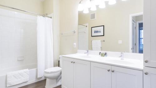 een witte badkamer met een wastafel en een toilet bij Landing - Modern Apartment with Amazing Amenities (ID2905X13) 