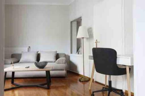 a living room with a couch and a chair at Central House in Plaka in Athens