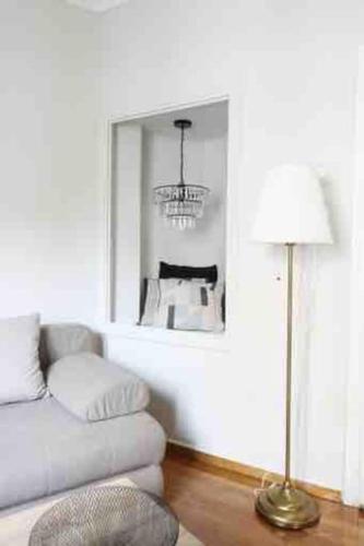 a living room with a couch and a lamp at Central House in Plaka in Athens
