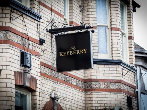 a black sign on the side of a building at The Keyberry Hotel in Newton Abbot