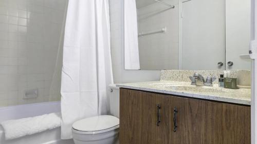a bathroom with a toilet and a sink and a shower at Landing - Modern Apartment with Amazing Amenities (ID9305X02) in Ballwin