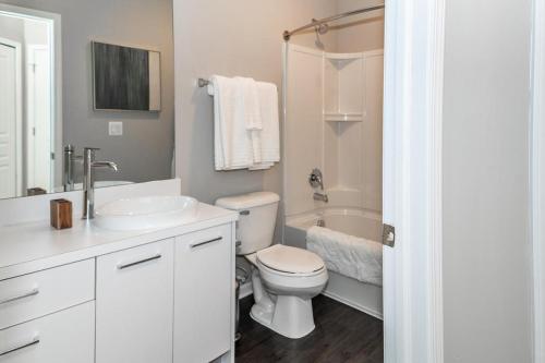 a white bathroom with a toilet and a sink at Landing - Modern Apartment with Amazing Amenities (ID4378) in Auburn Hills