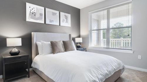 a bedroom with a white bed and a window at Landing - Modern Apartment with Amazing Amenities (ID9798X32) in Chapel Hill