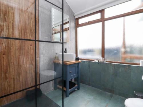 a bathroom with a sink and a mirror at The Lodge in Ulverston