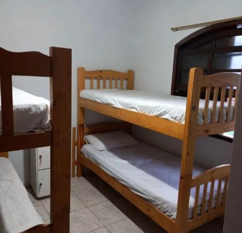 a couple of bunk beds in a room at Hostel Bike Point Caraguatatuba in Caraguatatuba