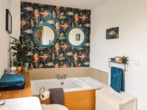 a bathroom with a tub and a floral wallpaper at 4 Bed in Hayton SZ119 in Hayton