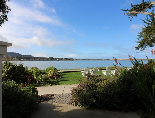 a group of chairs sitting next to a lake at Back Bay Inn in San Luis Obispo