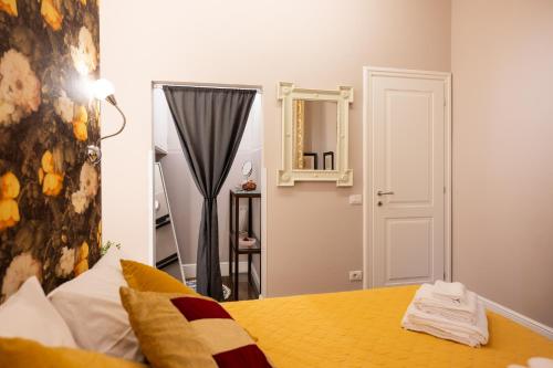 a bedroom with a bed and a mirror on the wall at Smooth Mansion in Ponte Vecchio in Florence