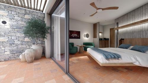 a bedroom with a large bed and a stone wall at Maison Meltem in Agia Pelagia