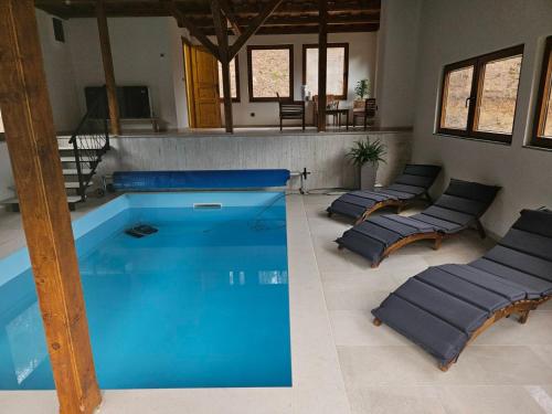 a large swimming pool with lounge chairs around it at Imanje Izgubljena Dolina in Lepoglava