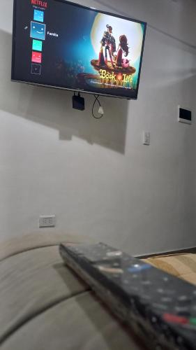 a flat screen tv hanging on a wall at Sueños Del Pilar II in Godoy Cruz