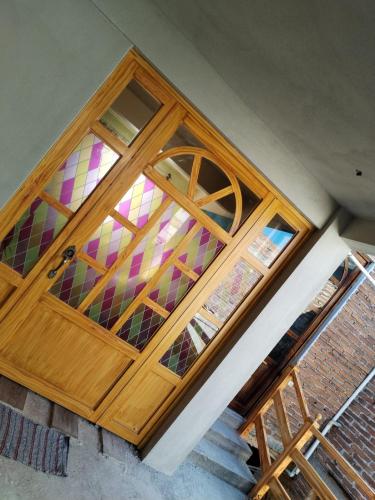 a wooden door with a stained glass window at Mariposas in Chignahuapan