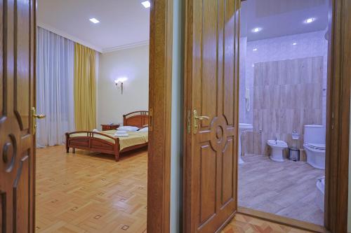 a bathroom with a bedroom with a bed and a door at Araks Hotel Complex in Gyumri