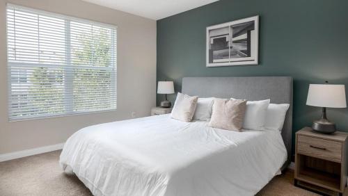 a bedroom with a white bed and a window at Landing - Modern Apartment with Amazing Amenities (ID4410X01) in Lewis Center