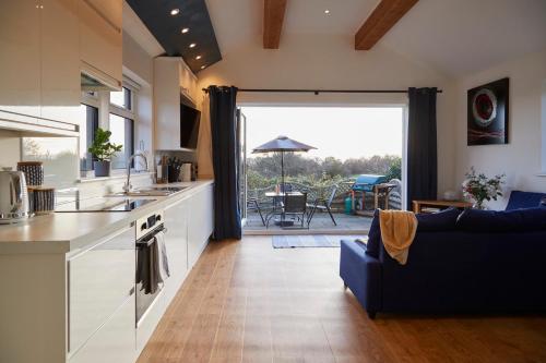 a kitchen and living room with a view of a patio at Brand new purpose built annex :- The Stables in Halifax