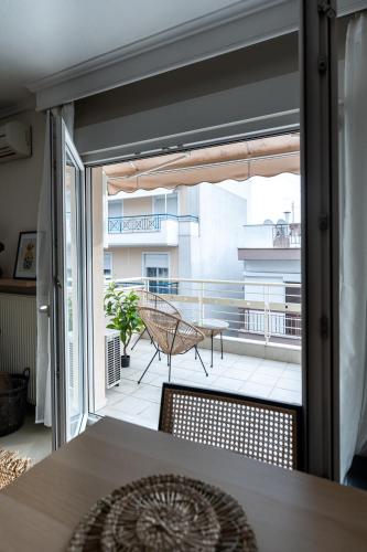 a balcony with a table and a view of a patio at Pomegranate Luxury Penthouse Maisonette with Stunning Terrace #Free Parking# by BiNoBi! in Thessaloniki