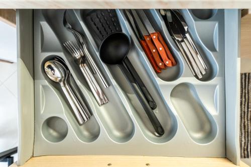 a drawer filled with silver utensils at Pomegranate Luxury Penthouse Maisonette with Stunning Terrace #Free Parking# by BiNoBi! in Thessaloniki