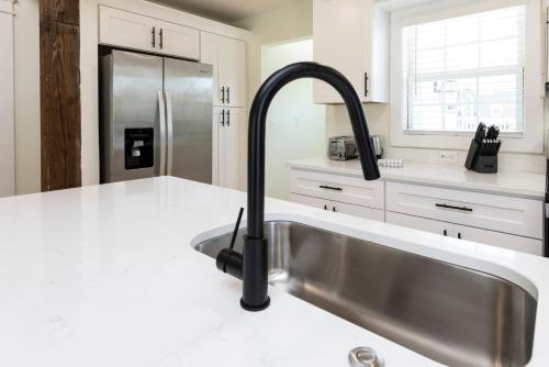 a kitchen with a sink and a faucet at Cape Henry House Inn at Old Beach in Virginia Beach