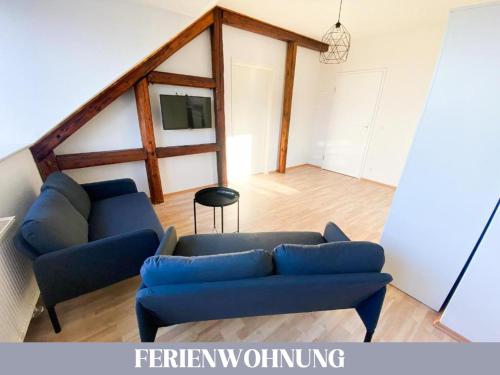 a living room with a blue couch and a table at Hotel Lamm in Pforzheim