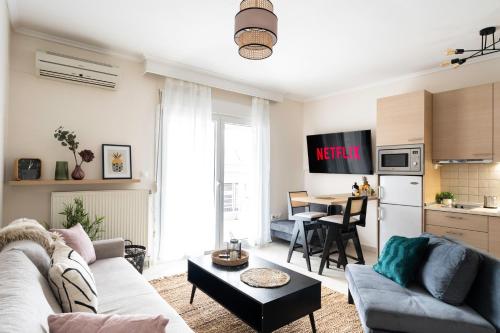 a living room with a couch and a table at Pomegranate Luxury Penthouse Maisonette with Stunning Terrace #Free Parking# by BiNoBi! in Thessaloniki
